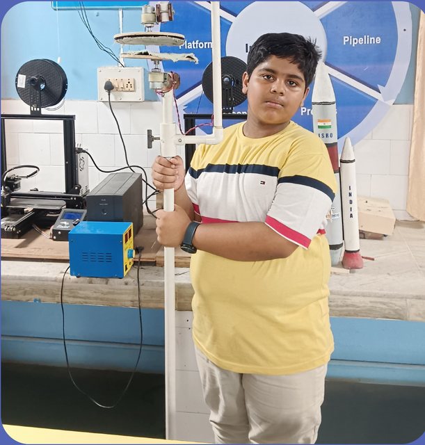 Debabrata Das holding the Multipurpose Cleaning Tool prototype in the innovation lab